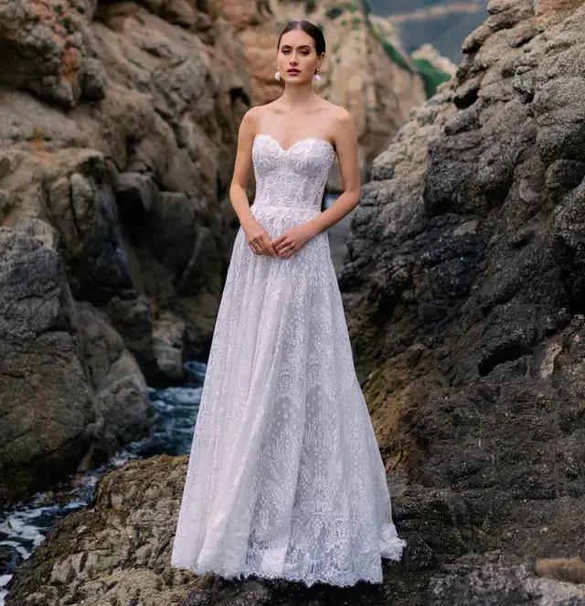 Model wearing a white Allure Wedding Dress